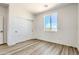 Vacant bedroom with closet, wood floors and natural light from the window at 16025 E Rancho Laredo Dr, Scottsdale, AZ 85262