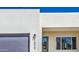 Contemporary home exterior featuring a gray garage door, front door and stylish address numbers at 16025 E Rancho Laredo Dr, Scottsdale, AZ 85262