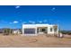 Stunning modern home featuring clean lines, neutral colors, desert landscaping, and mountain views at 16025 E Rancho Laredo Dr, Scottsdale, AZ 85262