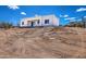 Contemporary home with a covered patio surrounded by desert landscaping at 16025 E Rancho Laredo Dr, Scottsdale, AZ 85262