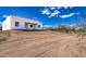 Modern home with clean lines and desert landscaping under a blue sky at 16025 E Rancho Laredo Dr, Scottsdale, AZ 85262
