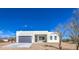Modern home featuring a gray garage door and desert landscaping at 16025 E Rancho Laredo Dr, Scottsdale, AZ 85262