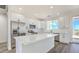 Bright, modern kitchen with white cabinetry, stainless steel appliances, and a large center island at 16025 E Rancho Laredo Dr, Scottsdale, AZ 85262