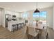 Bright, open kitchen features white cabinetry, island seating, and stainless steel appliances at 16025 E Rancho Laredo Dr, Scottsdale, AZ 85262