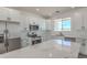 Bright kitchen features marble countertops, stainless appliances, white cabinets, and ample counter space at 16025 E Rancho Laredo Dr, Scottsdale, AZ 85262