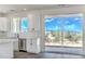 Bright, white kitchen with stainless steel appliances, white countertops and a desert view at 16025 E Rancho Laredo Dr, Scottsdale, AZ 85262