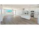 Open-concept living space boasts ample natural light, wood-look floors, and stylish kitchen access at 16025 E Rancho Laredo Dr, Scottsdale, AZ 85262