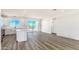 Open floor plan with white kitchen cabinets, island, and sliding glass doors with desert views at 16025 E Rancho Laredo Dr, Scottsdale, AZ 85262
