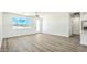 Bright living room area with wood flooring, ceiling fan and a door to the outdoor space at 16025 E Rancho Laredo Dr, Scottsdale, AZ 85262