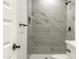 Close up of new walk-in shower with marble tile and black fixtures at 16025 E Rancho Laredo Dr, Scottsdale, AZ 85262