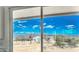 Expansive view from the home's window showcases a desert landscape and bright blue skies at 16025 E Rancho Laredo Dr, Scottsdale, AZ 85262