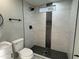 Updated bathroom featuring a sleek, tiled shower and modern fixtures at 1720 W Michigan Ave, Phoenix, AZ 85023