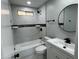 Updated bathroom featuring stylish black fixtures, modern tile, and a bathtub with shower at 1720 W Michigan Ave, Phoenix, AZ 85023
