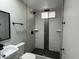Elegant bathroom with modern black fixtures, black-accented tile and a walk-in shower at 1720 W Michigan Ave, Phoenix, AZ 85023