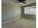 Serene bedroom with neutral paint, tile floors, and a large window overlooking the backyard at 1720 W Michigan Ave, Phoenix, AZ 85023