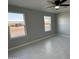 Bedroom with two windows, ceiling fan, and tile flooring at 1720 W Michigan Ave, Phoenix, AZ 85023