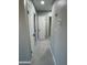 Neutral hallway with white doors, modern hardware, and tile flooring at 1720 W Michigan Ave, Phoenix, AZ 85023