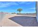 A large low-maintenance backyard area enclosed by concrete block wall fencing at 19365 N Pietra Dr, Maricopa, AZ 85138