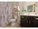 Bathroom with a shower curtain and dark wood cabinets at 19365 N Pietra Dr, Maricopa, AZ 85138