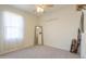 Empty bedroom with neutral carpet and a large window at 19365 N Pietra Dr, Maricopa, AZ 85138