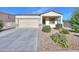 Inviting single-story home with a two-car garage and meticulously landscaped front yard at 19365 N Pietra Dr, Maricopa, AZ 85138