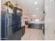 Well-lit kitchen with dark wood cabinetry, granite countertops, and modern appliances at 19365 N Pietra Dr, Maricopa, AZ 85138