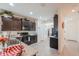 Modern kitchen with dark wood cabinets, granite countertops, and stainless steel appliances at 19365 N Pietra Dr, Maricopa, AZ 85138