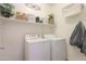 Well-lit laundry room with a washer and dryer at 19365 N Pietra Dr, Maricopa, AZ 85138