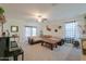 Cozy living room with a comfortable sectional sofa, a ceiling fan, and stylish decor at 19365 N Pietra Dr, Maricopa, AZ 85138