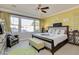 Bright bedroom with large window, cozy chair, and unique decor with 'Love' sign at 1952 W Yellowstone Way, Chandler, AZ 85248