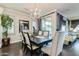 Formal dining room with elegant chandelier, dark wood table, and views to the backyard at 1952 W Yellowstone Way, Chandler, AZ 85248