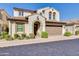 Charming two-story home with a tile roof, arched entryway, manicured bushes, and two car garage at 1952 W Yellowstone Way, Chandler, AZ 85248