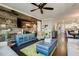 Stylish living room featuring a rustic accent wall, hardwood floors, and views of the dining room at 1952 W Yellowstone Way, Chandler, AZ 85248