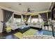 Comfortable living room with large windows, plush sofas, and a ceiling fan at 1952 W Yellowstone Way, Chandler, AZ 85248