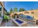 Relaxing outdoor living space with a gas fire pit, built-in seating, and lush landscaping for cozy gatherings at 1952 W Yellowstone Way, Chandler, AZ 85248