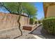 Secluded backyard with desert landscaping, stone pathway, and a wooden garden bed at 1958 W Legends Way, Anthem, AZ 85086
