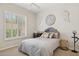 Bedroom with a white ceiling fan and decorative wall hangings over a bed with a blue headboard at 1958 W Legends Way, Anthem, AZ 85086