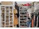 Organized walk-in closet featuring shelving filled with shoes, handbags and other accessories, and hanging clothes at 1958 W Legends Way, Anthem, AZ 85086