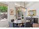Bright dining room with modern chandelier and views of the landscaped yard at 1958 W Legends Way, Anthem, AZ 85086