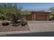 Exterior of home with desert landscaping and a two-car garage at 1958 W Legends Way, Anthem, AZ 85086