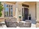 Charming front porch with outdoor seating, plants and stylish decor at 1958 W Legends Way, Anthem, AZ 85086