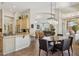 Open kitchen and dining area featuring a breakfast bar and a chandelier over the table at 1958 W Legends Way, Anthem, AZ 85086