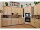 Modern kitchen with ample cabinet space, built-in wine storage, and stainless steel appliances at 1958 W Legends Way, Anthem, AZ 85086