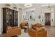 Cozy living room with leather chairs and views into adjacent rooms at 1958 W Legends Way, Anthem, AZ 85086