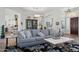 Beautifully furnished living room with a comfortable gray sofa and elegant decor at 1958 W Legends Way, Anthem, AZ 85086