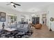 Spacious living room featuring a plush gray sofa and tile flooring, perfect for entertaining at 1958 W Legends Way, Anthem, AZ 85086