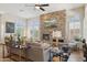 Inviting living room with a stunning stone fireplace and large windows at 1958 W Legends Way, Anthem, AZ 85086