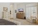 Spacious main bedroom featuring a dresser, plantation shutters, and a comfortable armchair at 1958 W Legends Way, Anthem, AZ 85086