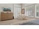 Bright main bedroom with large windows, plantation shutters, TV, and an armchair at 1958 W Legends Way, Anthem, AZ 85086