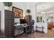 Dedicated home office featuring file cabinets, dark wood desk, and a comfortable office chair at 1958 W Legends Way, Anthem, AZ 85086